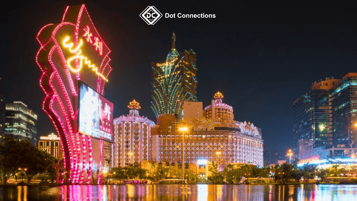 Night view of famous casinos in Macau illuminated with neon lights.
